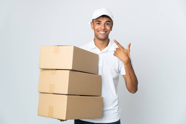 Delivery Brazilian man isolated on white background giving a thumbs up gesture - Photo, Image