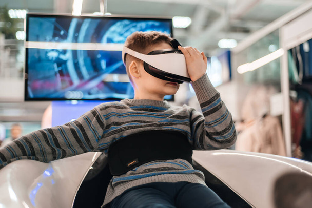 Boy in virtual reality glasses playing the game - Fotó, kép