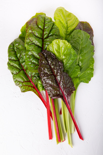 Bunch of fresh chard leaves on white background. Top view. - Photo, Image