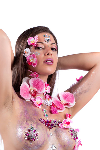 Woman with beautiful body paint artwork and flowers on her nude chest, a concept that helps against breast cancer awareness and women liberation. - Фото, зображення