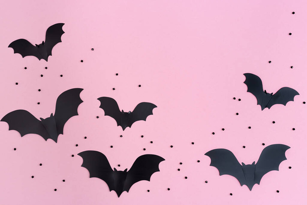 Flat lay with Black bats for halloween party. Paper decorations on pink background for holiday card or invitation. Copy space. - Zdjęcie, obraz