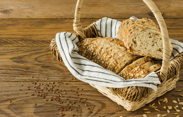 Gluten-free vegan bread with no animal products. Vegetarian bread with oatmeal, banana flavor in a basket on a wooden rustic table, sliced and ready to serve - Photo, Image