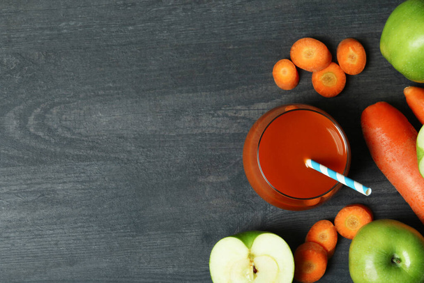 Glass of juice and ingredients on dark wooden background - Photo, Image