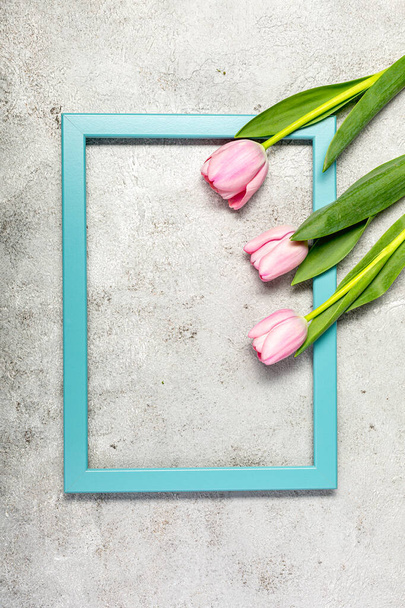 Fresh pink tulip flowers on ultimate gray wall - Fotó, kép