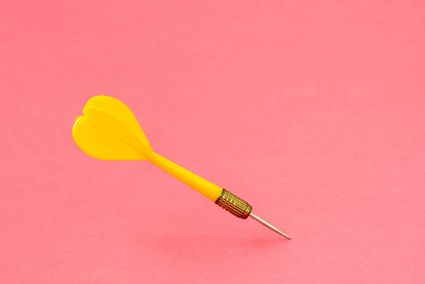 Yellow dart arrow on the pink background. Copy space. - Fotoğraf, Görsel