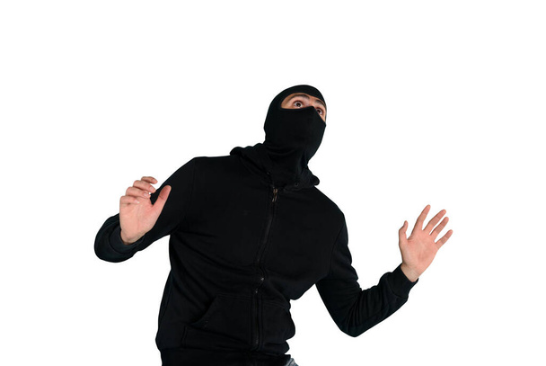 Thief with balaclava was spotted trying to steal in a apartment. Scared expression - Photo, Image