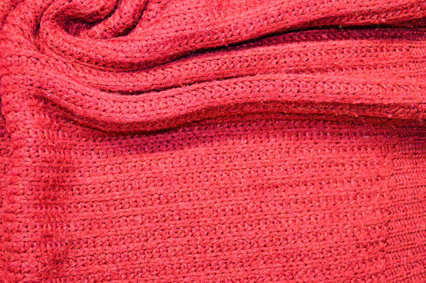 Arka plan olarak kırmızı örülmüş tekstil deseni. Kumaş üzerindeki kırmızı örgü kumaş dokusuna yaklaş. Buruşmuş kumaş dokusu - Fotoğraf, Görsel