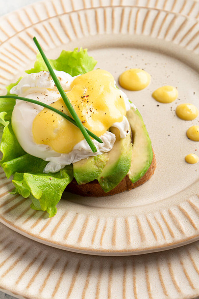 egg benedict on a plate, plating, close-up - Fotó, kép