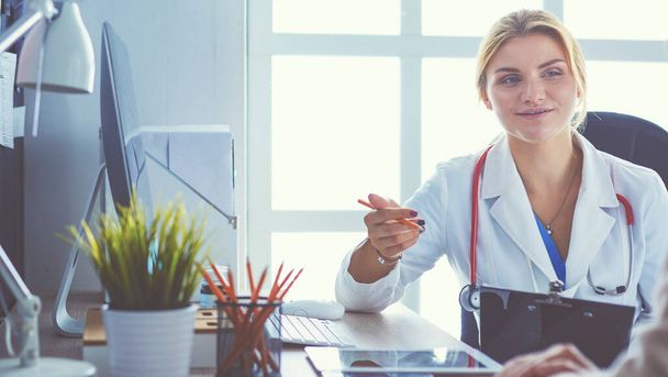 Female doctor holding application form while consulting patient - Фото, зображення