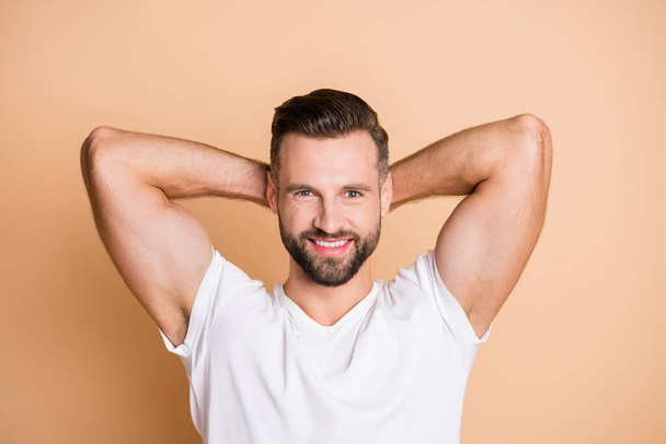 Top above high angle photo of young happy positive smile stubble guy hands behind head rest relax break pause isolated over beige color background - Foto, afbeelding