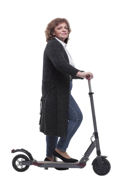 side view. confident woman with an electric scooter looking at the camera - Фото, изображение