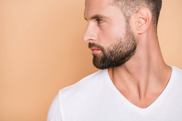 Cropped profile side photo of young handsome stubble man serious look empty space isolated over beige color background - Φωτογραφία, εικόνα