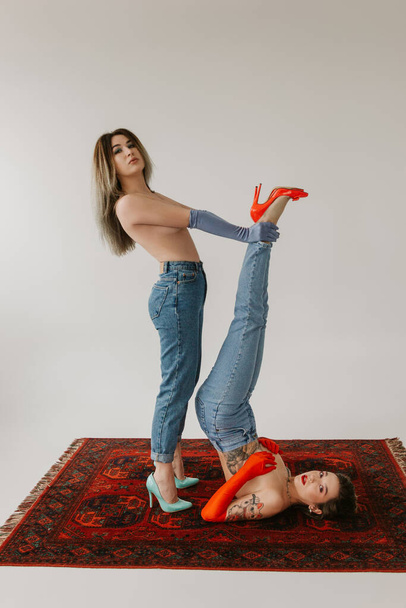 two sexy women wearing jeans on white background - Fotoğraf, Görsel