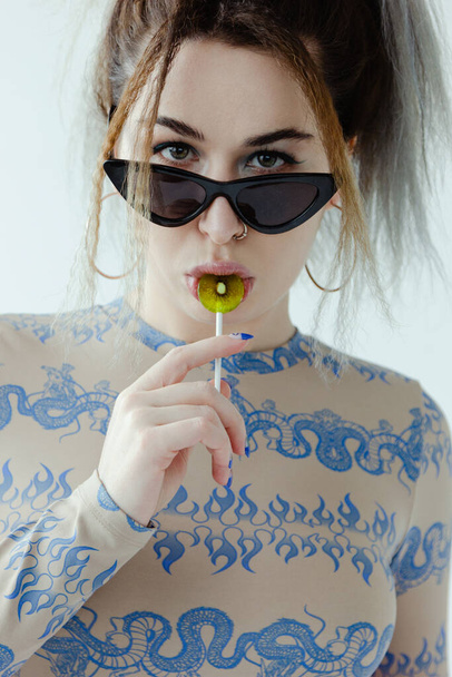 Beautiful woman with lollipop on white background - Foto, afbeelding