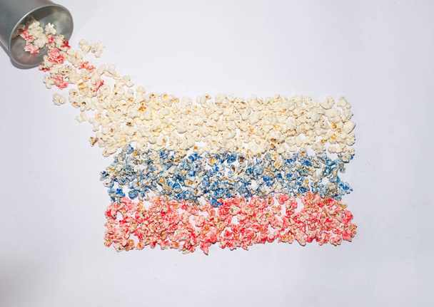 Russische vlag gemaakt van popcorn. Kleurrijke platte lay shot op een witte achtergrond. Abstract concept. Nationaliteitsideeën.  - Foto, afbeelding