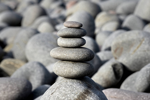 Pebble stack on the beach the stones represent balance and wellbeing of the mind - Photo, Image