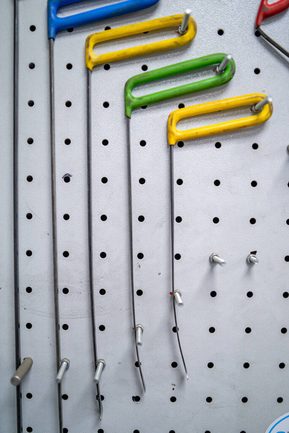 Bright colored special hooks using in PDR work process to remove dents  - Photo, Image