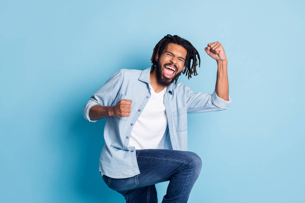 Portrait of attractive crazy cheerful guy celebrating having fun dancing isolated over bright blue color background - Φωτογραφία, εικόνα