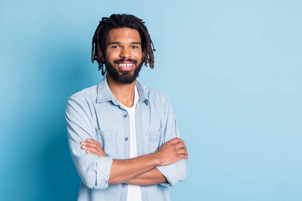 Portrait of attractive content cheerful guy wearing jeans shirt folded arms copy space isolated over bright blue color background - Φωτογραφία, εικόνα