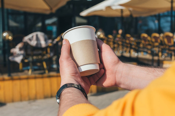 A man is drinking coffee in an outdoor restaurant - Φωτογραφία, εικόνα