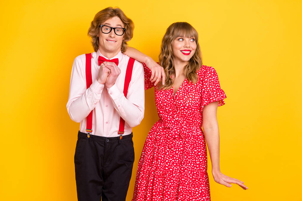 Photo portrait of couple spending time together in stylish outfits isolated on vibrant yellow background - Foto, immagini