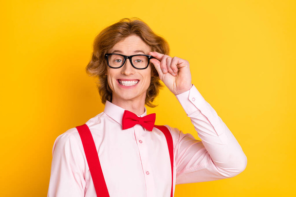 Photo portrait of guy with red hair smiling in spectacles shirt suspenders isolated on vibrant yellow background - Foto, imagen