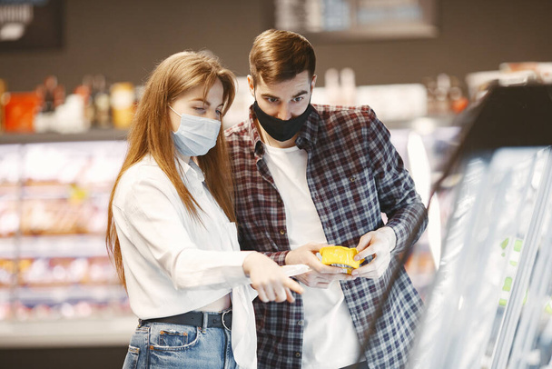 People in a medical mask in a supermarket - Фото, зображення