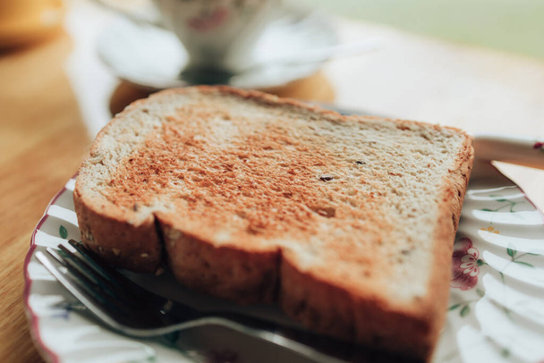 Plate with toasted bread on the wood table. Coffee and dessert concept. - 写真・画像