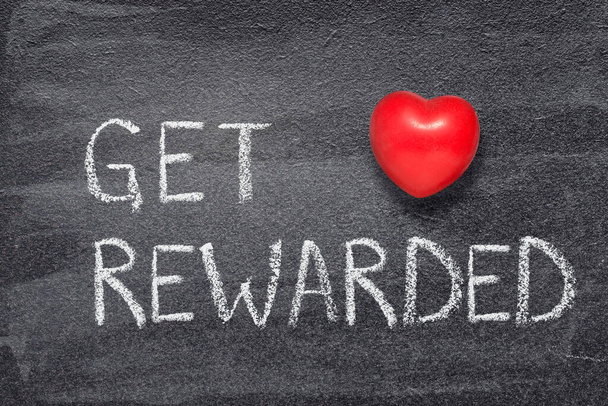 get rewarded phrase written on chalkboard with red heart symbol - Photo, Image