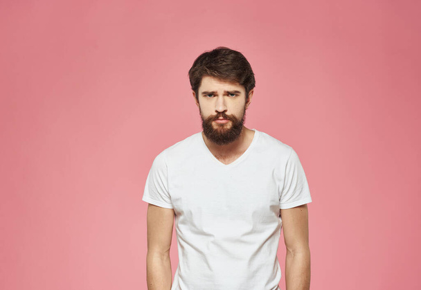 Man on a pink background in a white t-shirt  - Photo, image