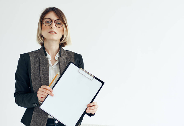 a woman in a formal suit holds a white sheet of paper in her hands Copy Space - Photo, Image