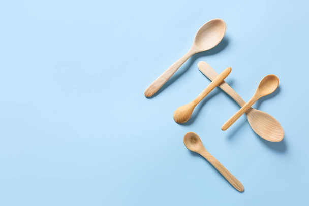 Wooden spoons on color background - Photo, Image