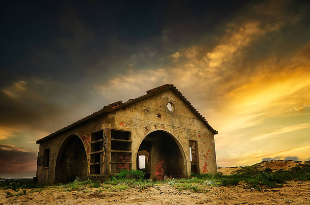 View of a ruined house in shades of yellow at sunset - Photo, Image