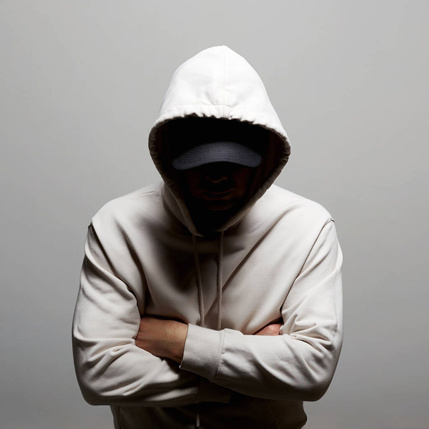 Person in Hood. Boy in a hooded sweatshirt. man in Hat - Fotografie, Obrázek