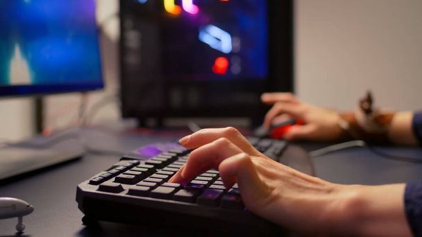 Close-up of gamer using RGB keyboard and mouse - Photo, Image
