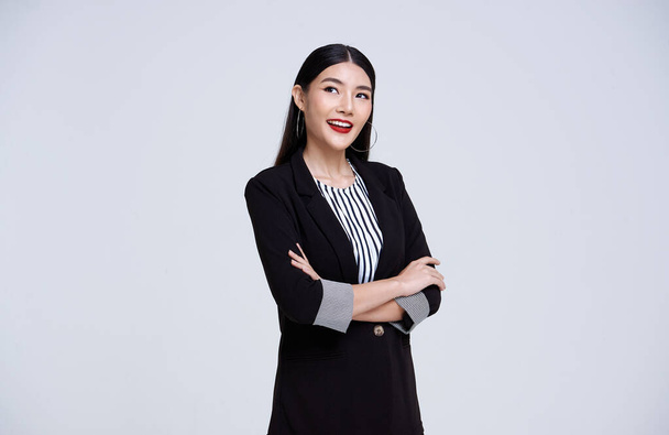 Smiling Confident Asian business woman over gray background. - Foto, Imagen