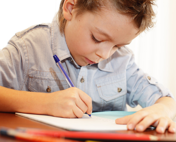 Little boy does a homework - Фото, изображение