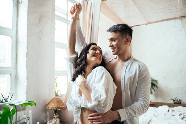 young couple spending time and dancing in their beautiful countryside house - Foto, Bild