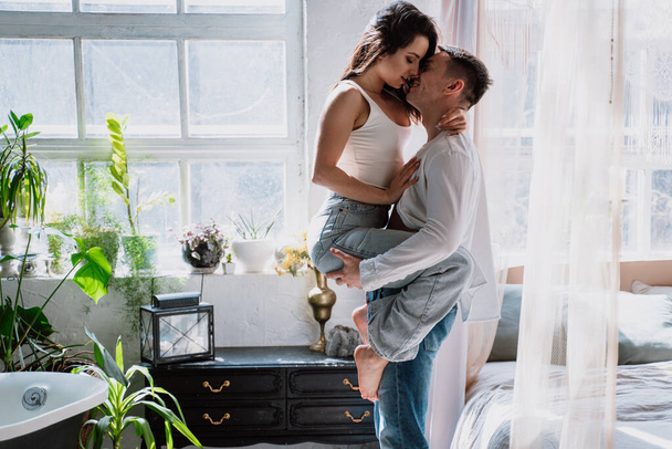 young couple spending time in their beautiful countryside house. Romantic lifestyle moments - Фото, изображение