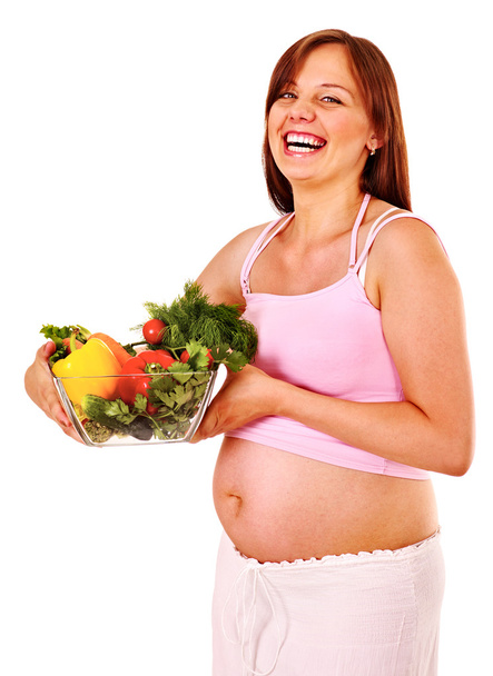 Вагітна жінка їсть овочі
. - Фото, зображення