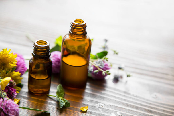 Essential oil bottles with medicinal plants and herbs extracts, spa and aromatherapy alternative medicine - 写真・画像