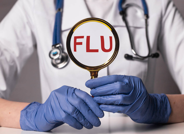 Flu or influenza inscription, word in doctor hands. - Foto, imagen