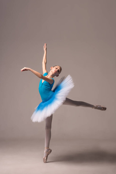 Ballerina in a ballet tutu and pointe shoes. The child ballerina is dancing. Girl on isolate - Photo, Image