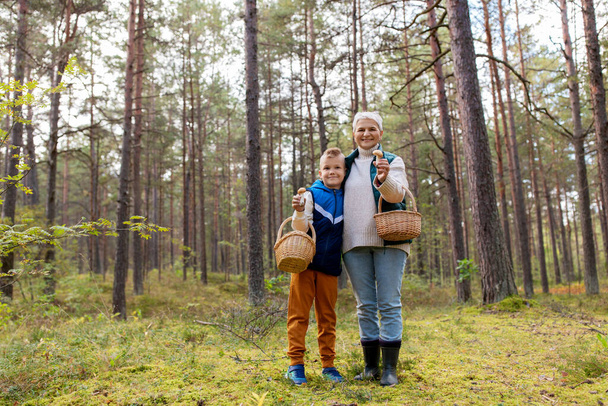 grandmother and grandson with mushrooms in forest - Foto, Imagem