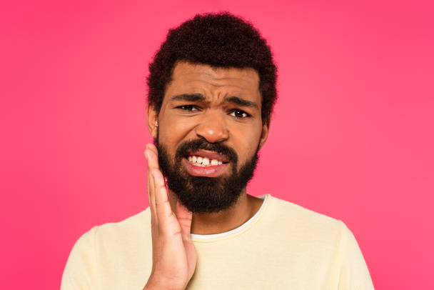 african american man suffering from tooth ache isolated on pink - Foto, imagen