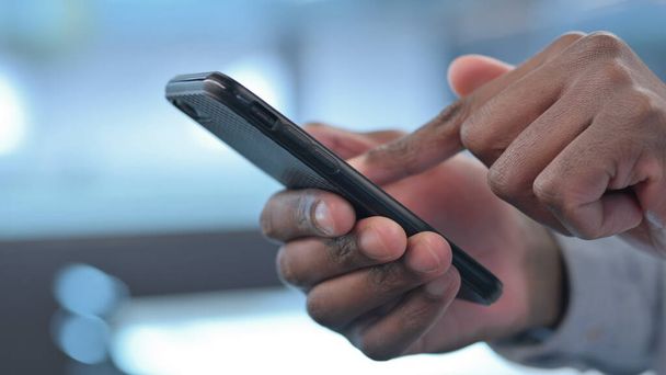 Hands Close up of African Man using Smartphone - Photo, image