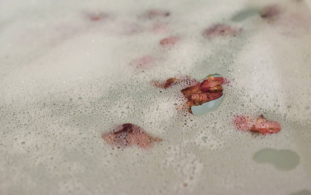 Bagno di bolle con petali di rosa da vicino - Foto, immagini