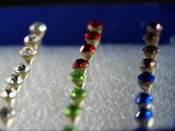 Boxes of different colors with lots of jewelry. Selective focus. Macro. - Photo, Image