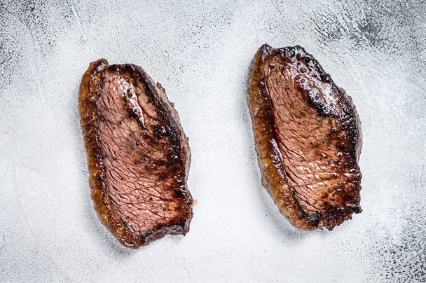 Grilled top sirloin cap or picanha steak. White background. Top view - Photo, Image