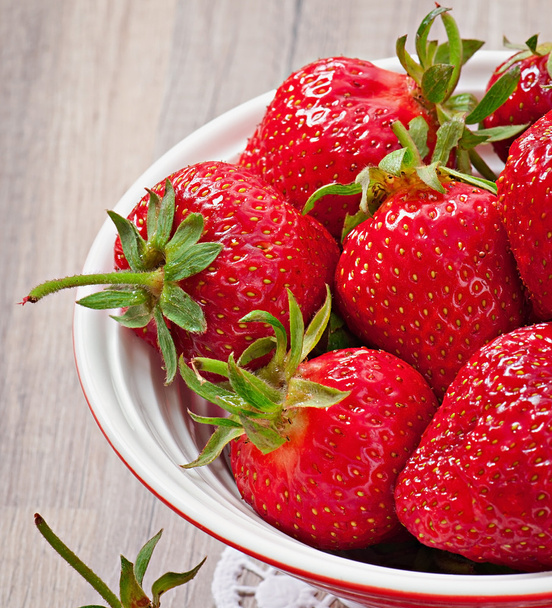 Close up of strawberry on wooden background - Foto, Bild